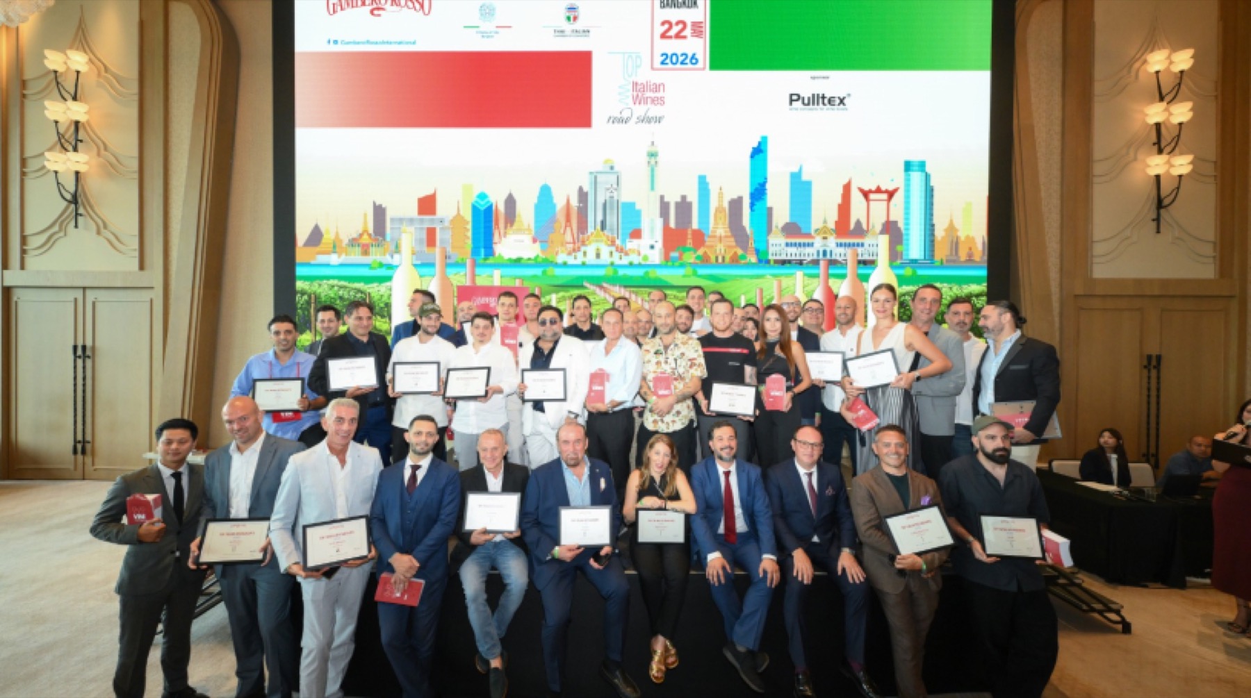 A large group of guests assembled in front of the roadshow screen